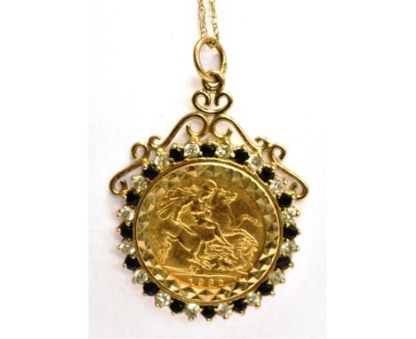 HALF-SOVEREIGN, 1982, LOOSELY MOUNTED IN A VINTAGE 9CT GOLD PENDANT with an alternate small-round black and white sapphire bo