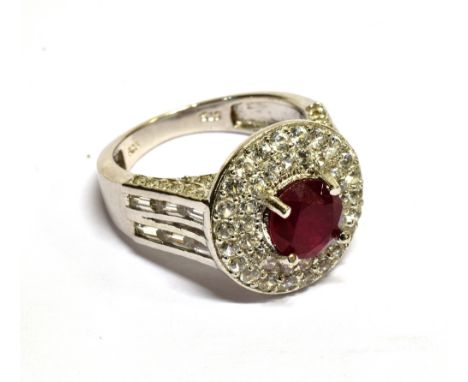 A MODERN SILVER, FRACTURE-FILLED-RUBY AND PASTE 'TARGET' CLUSTER RING  centred with around fracture-filled ruby, approx. 7mm 