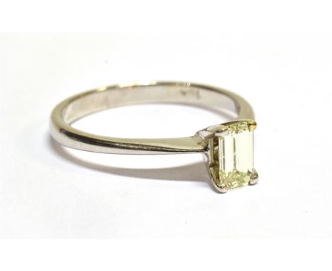 A VINTAGE DIAMOND SOLITAIRE RING the cut-corner rectangular step-cut stone approx. 0.45cts, claw set in white between knife-e