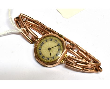 AN EARLY 20TH CENTURY LADY'S 9CT GOLD CASED ROUND BRACELET WATCH, CIRCA 1927 the silvered engine-turned dial with a mother of