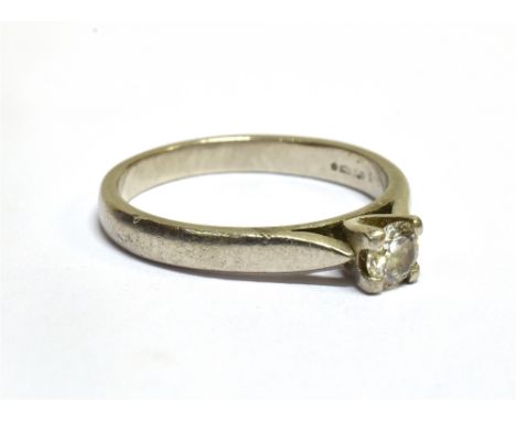A MODERN PLATINUM AND DIAMOND SOLITAIRE RING the round brilliant approx. 0.24cts, in a simple four-claw setting between split