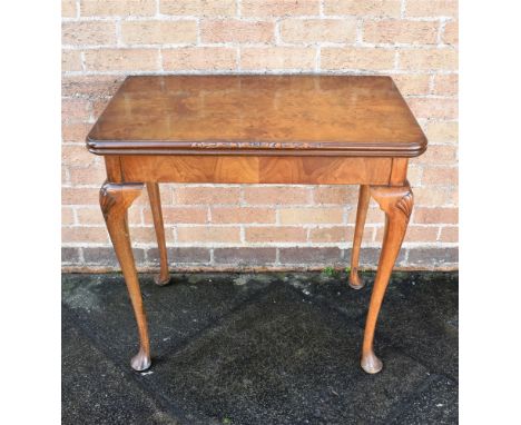 A BURR WALNUT CARD TABLE  on cabriole supports with shell carved decoration, 77cm wide