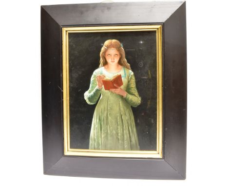 A POTTERY TILE PANEL  decorated with a figure of a young girl reading a book, fleur-de-lys impresssed mark to reverse, the ti