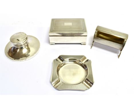 A SMOKERS SILVER COMPOSITE DESK SET COMPRISING; A SILVER CYLINDRICAL ENGINE-TURNED CIGARETTE BOX with a part rotating cover, 