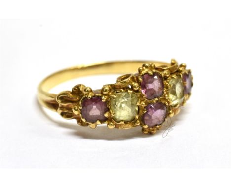 A VICTORIAN GOLD, GARNET AND CHRYSOLITE RING centred with a pair of cushion-shaped garnets flanked by similarly cut chrysolit