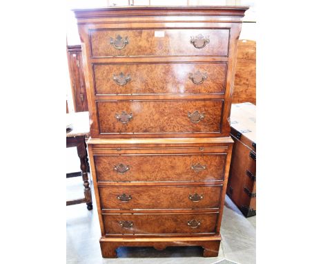 A CONTEMPORARY MAHOGANY AND BURR WOOD CHEST ON CHEST of six graduated drawers with brushing slide and on bracket feet 137cm, 