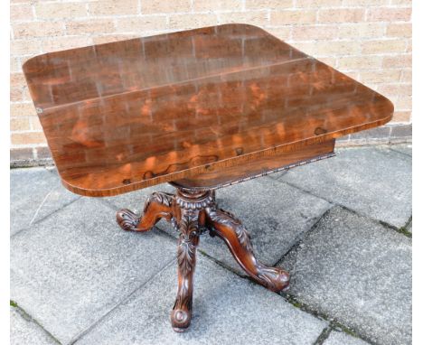A 19th Century Rosewood Card Table on a highly carved quatrefoil base with brass castors, 92cm wide.&nbsp;&nbsp;