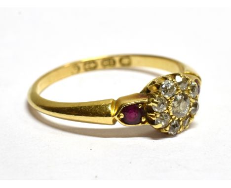 A VICTORIAN 18CT GOLD AND DIAMOND CLUSTER RING WITH RUBY SHOULDERS the nine graduated old-cut diamonds approx. 0.30cts total,