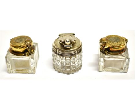THREE 19TH CENTURY MOUNTED CLEAR-GLASS TRAVELLING INK WELLS comprising; an engine-turned gilt white metal round example with 