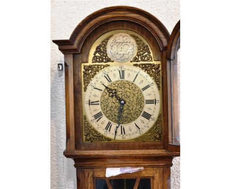 AN OAK CASED LONGCASE CLOCK  with triple weight and Westminster chiming movement, the silvered chapter ring signed 'Cozens &a