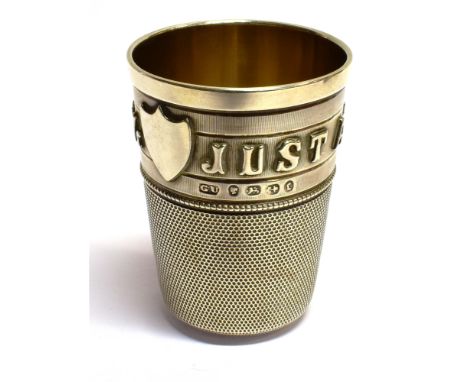A VICTORIAN SILVER TOT CUP IN THE FORM OF AN OVERSIZE THIMBLE 'JUST A THIMBLE FULL' three-quarters engine-turned and with a v