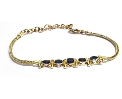 A MODERN SILVER AND SAPPHIRE FIVE STONE BRACELET  the front centred with a cushion-shaped sapphire between oval and drop-shap
