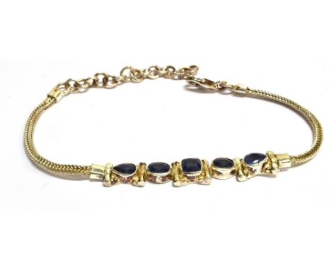 A MODERN SILVER AND SAPPHIRE FIVE STONE BRACELET  the front centred with a cushion-shaped sapphire between oval and drop-shap