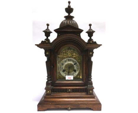 A CONTINENTAL 8-DAY MANTLE CLOCK  in architectural walnut case, 31cm wide 56cm high