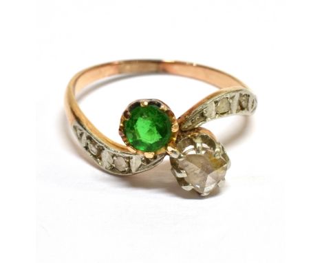 A MID-20TH CENTURY GOLD, DIAMOND AND GREEN PASTE CROSS-OVER RING  the head claw set with a pear-shaped rose diamond and a sma