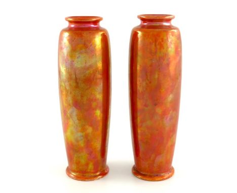 A pair of Ruskin lustre rolling pin vases, 1921, elongated slender shouldered barrel form, orange glaze, impressed marks, 21c