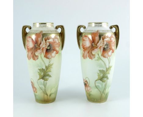 A pair of Reinhold Schlegelmilch, R S Suhl vases, twin handled form, decorated with poppies, highlighted in gilt, 21cm high (