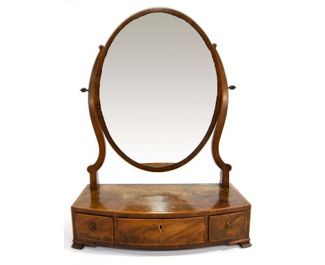 A George III mahogany and satinwood strung swing toilet mirror, oval glass, bow fronted three drawers, on bracket feet, 60cm 