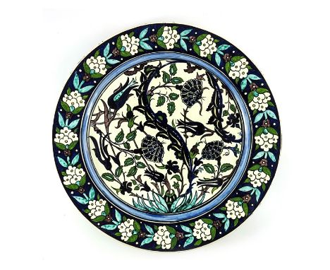 Torquato Castellani, an Italian faience dish, 1879, painted in the Iznik Persian style with flowering plant in a foliate bord