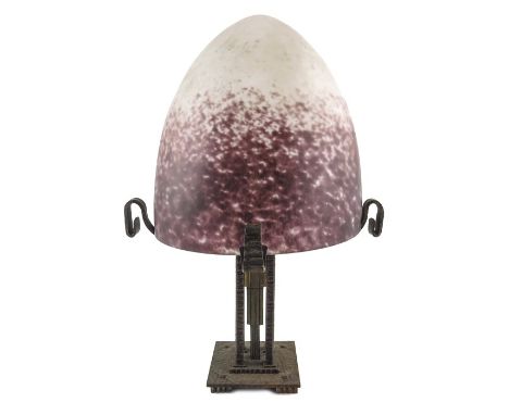 An Art Deco wrought iron, lacquered brass and pate de verre glass table lamp, the domed shade of egg form, mottled opaque and