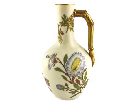 A Royal Worcester blush ivory jug, 1889, shouldered form with bamboo moulded handle, painted with floral specimens, highlight