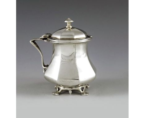 Goldsmiths and Silversmiths Company, London 1909, an Arts and Crafts silver mustard pot, ocatgonal baluster form with pierced