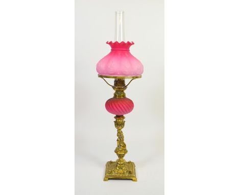 A Victorian cast brass and opaque glass oil lamp, Renaissance style, the column modelled as a Harpy, supporting a wrythen fro