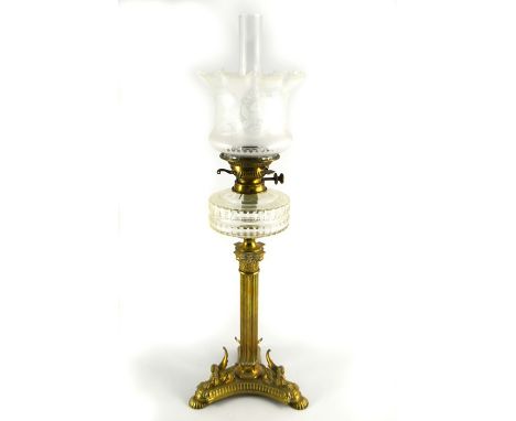 A Victorian brass and glass oil lamp, the Corinthian column on tricorn base with three cast winged Sphinx figures, supporting