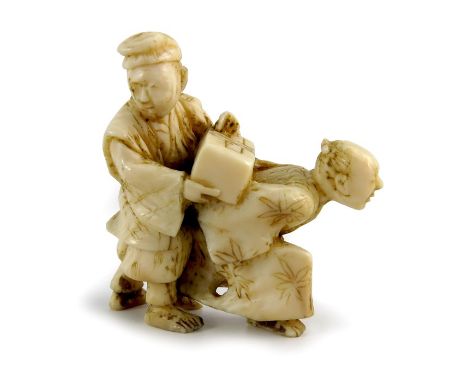 A Japanese ivory netsuke, Meiji, modelled as two men with a box, 4cm 