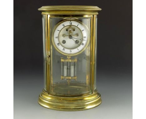 A four glass and brass mantle clock, 19th century, the oval case with stepped plinth case, the gilt brass and ceramic dial wi