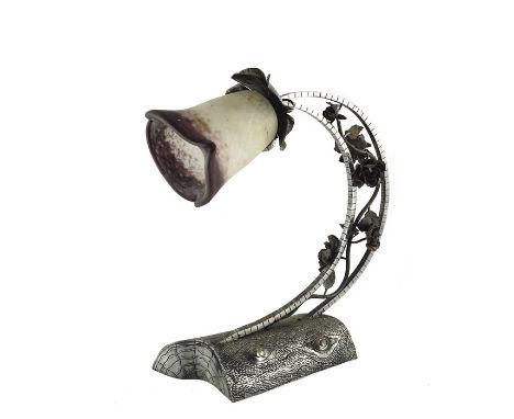 An Art Nouveau polished steel and wrought iron table lamp, the base naturalistically modelled as a log, the petal sconce supp