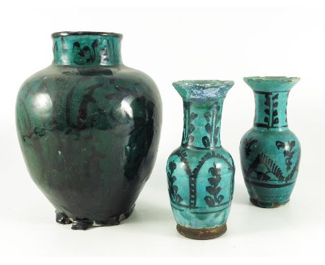 Three Persian ceramic vases, green glazed and painted, including a pair of necked shouldered vases and an ovoid vase, probabl