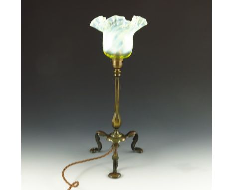 An Arts and Crafts brass Pullman type table lamp with straw opal glass shade, circa 1900, hexagonal section baluster stem  on