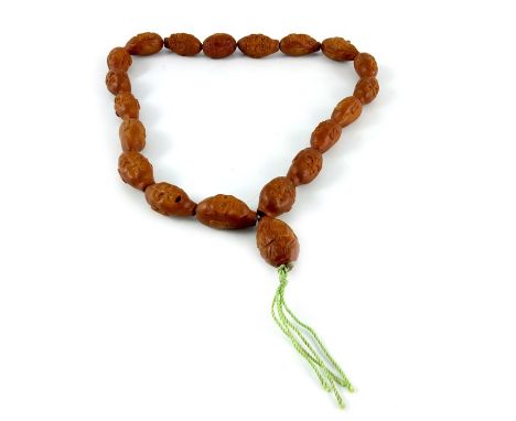 A Chinese carved nut string of beads, each modelled as one of the eighteen Lohan, Buddha and lantern, 52cm long