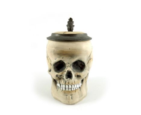 E Bohne Soehne, a novelty half litre character stein, realistically modelled as a skull, pewter mount and inset lid, undergla