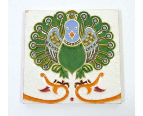 A Maw and Co dust pressed tile, in the style of Christopher Dresser, peacock design in blue and green, moulded marks, 15cm sq