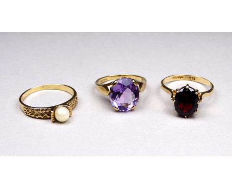 A 9ct gold amethyst set ring - the oval stone within a pierced claw setting, ring size L, weight 3.2g, together with a garnet