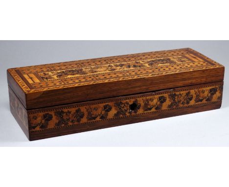 A mid 19th century Tunbridgeware games box and cribbage board, the rectangular box decorated with flowers within a geometric 