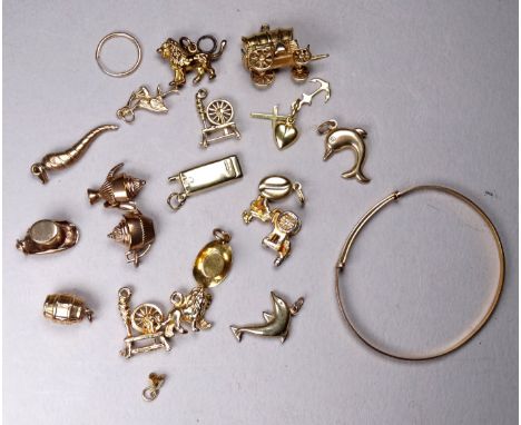 A quantity of 9ct gold charms - a variety of shapes, together with a 9ct gold child's bangle, total weight 20.3g and five gil