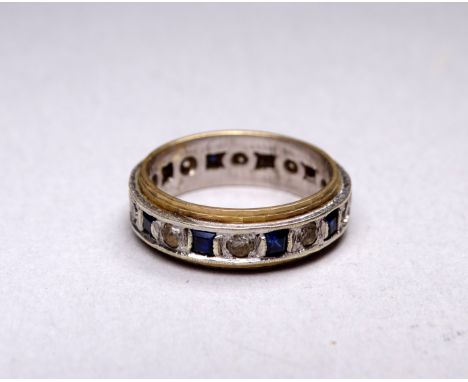 A sapphire and white stone eternity ring - set in 9ct yellow and white gold, size K, weight 3.7g.