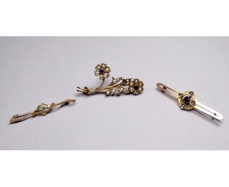 A 9ct gold bar brooch set a peridot - together with a 9ct gold garnet and pearl set bar brooch, weight 3.1g and another gilt 