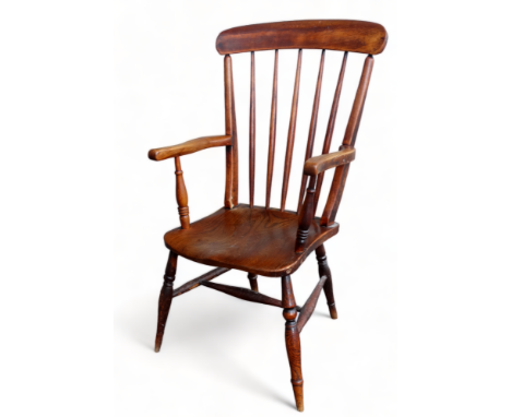 A late 19th century ash and elm Windsor style chair - with a top rail and stick back above arms and a contoured seat, on turn