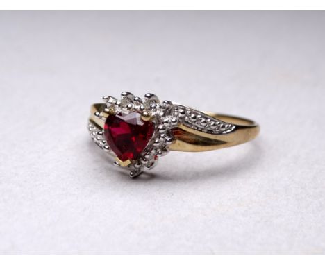 A 9ct gold ruby and diamond ring - with a heart shaped stone and crossover setting, size V, weight 2.2g. 