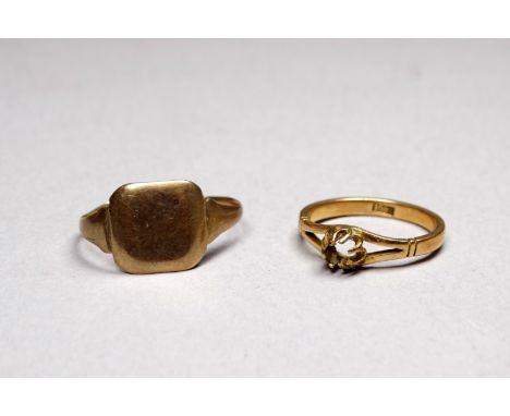An 18ct gold solitaire ring setting - size K/L, weight 2.3g, together with a 9ct gold signet ring, distressed, weight 1.9g.
