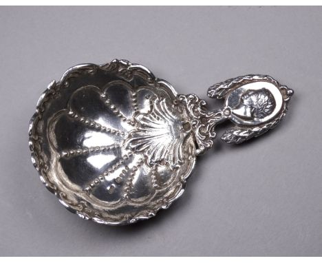A large elaborately decorated caddy spoon - import marks for London 1892, length 10.6cm, weight 32g. 