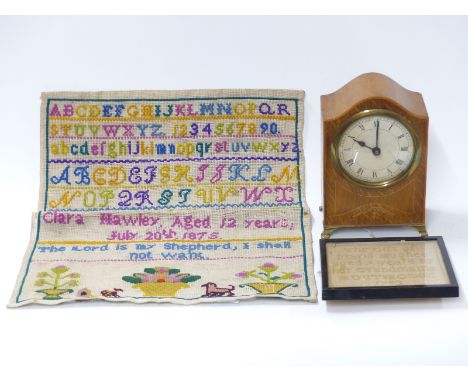 A wooden mantel clock, two samplers