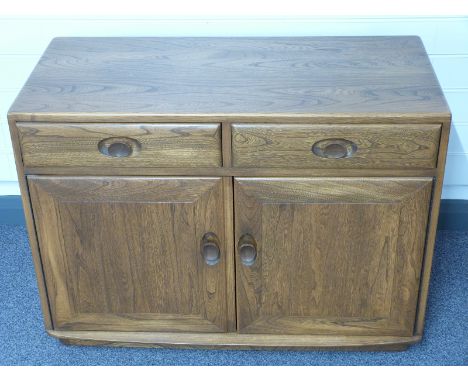 Small Ercol elm sideboard, having drawers and two cupboards W91 x D45 x H67cm