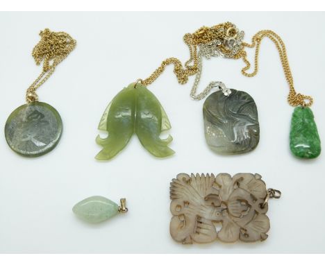 A jadeite pendant depicting two fish, nephrite jade pendant, azurite pendant & two carved hardstone pendants 