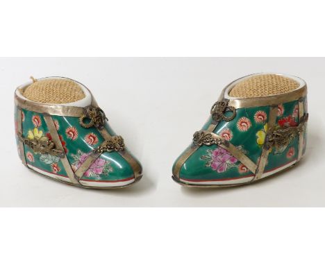A pair of Chinese white metal mounted ceramic shoes