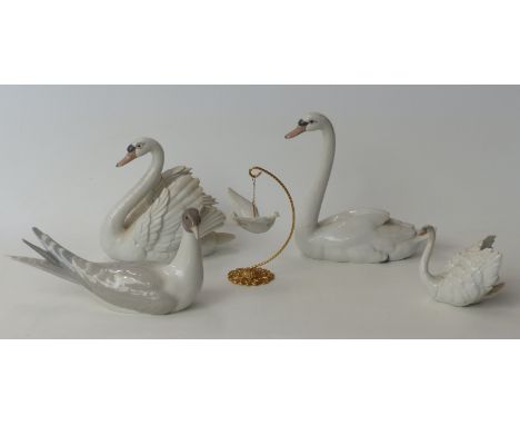 Three Lladro swan figures, a Lladro dove hanging from a metal stand and a gull 
